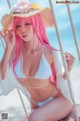 A woman with pink hair wearing a white bikini and a straw hat.