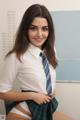 A woman in a school uniform is posing for the camera.